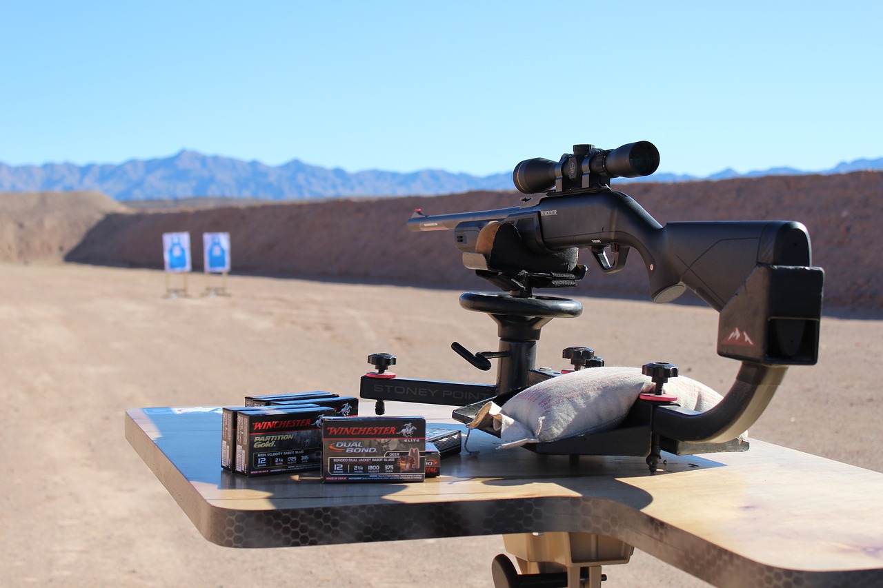 a rifle with attached rifle scope set up in an outdoor shooting range