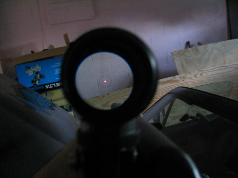 close-up photo showing what appears when looking through a red dot sight optic